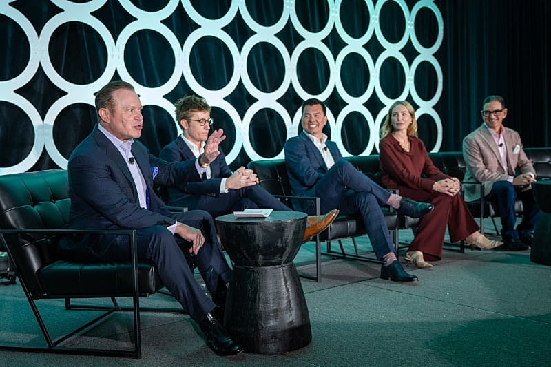 Panel discussion with five speakers on stage.