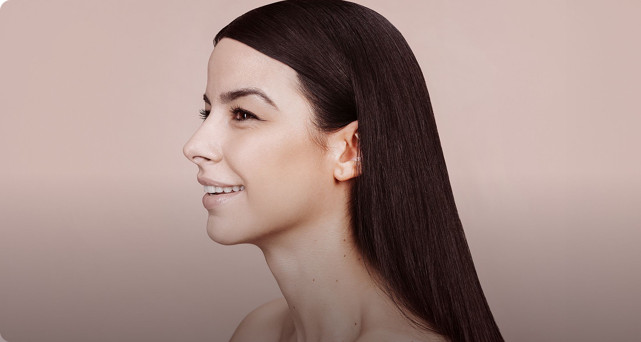 Profile of a smiling woman with sleek hair 