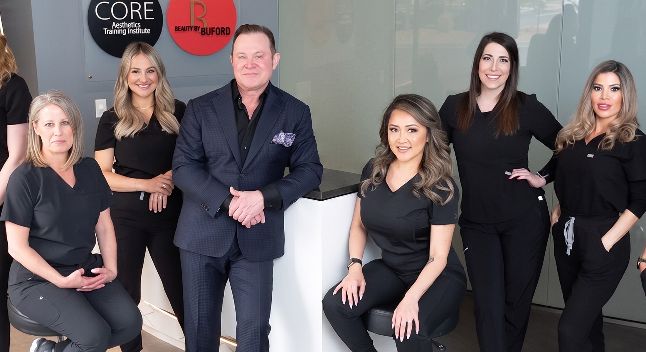 Aesthetic training team in modern studio setting.