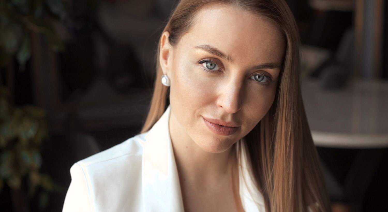 Woman with blue eyes in professional attire.